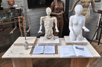 a display of the process of modeling a sculpture torso